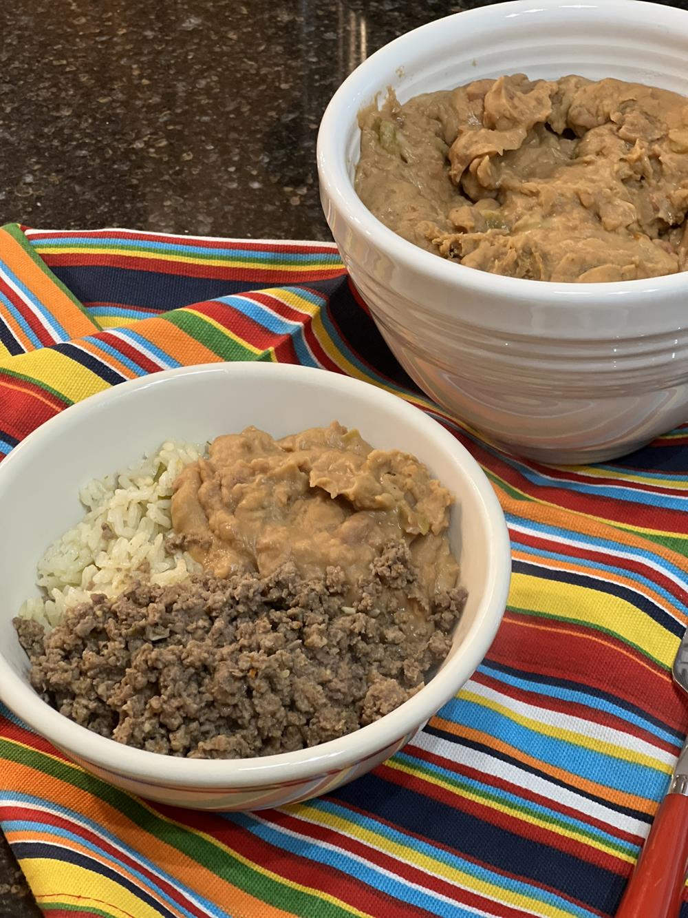 Cheesy Pinto Beans Rice Bowl in white bowl