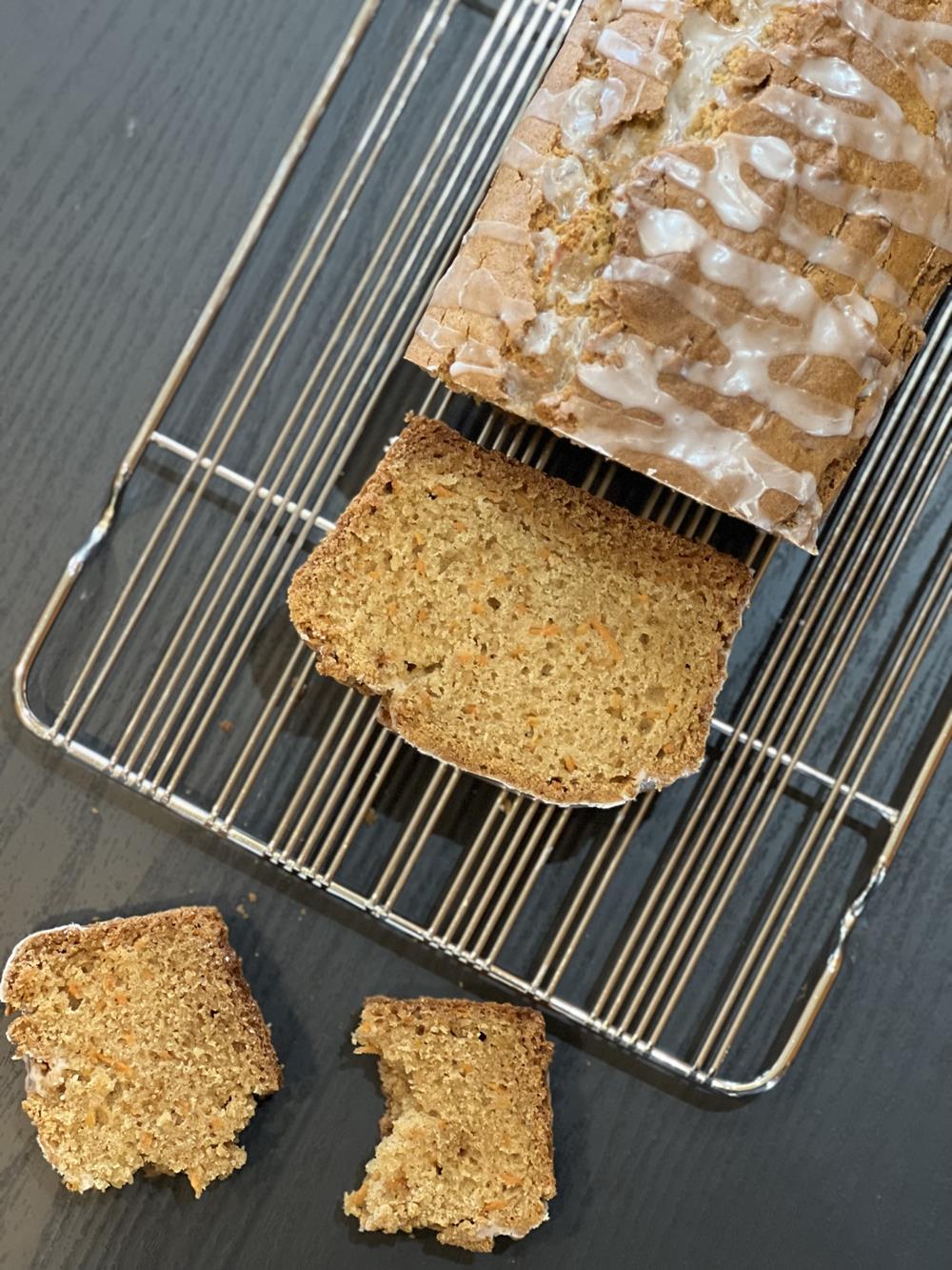 Gluten Free Carrot Bread sliced on a cooling rack on a black counter