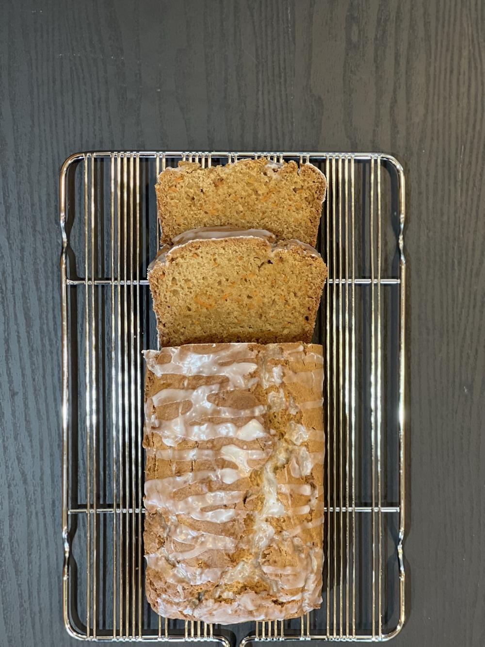 carrot bread slices on a cooling rack on black background