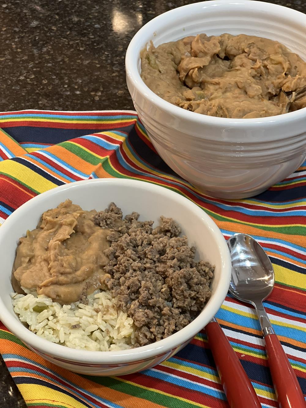 Instant Pot Green Chili Rice with meat and beans in a bowl and a bowl of beans in background