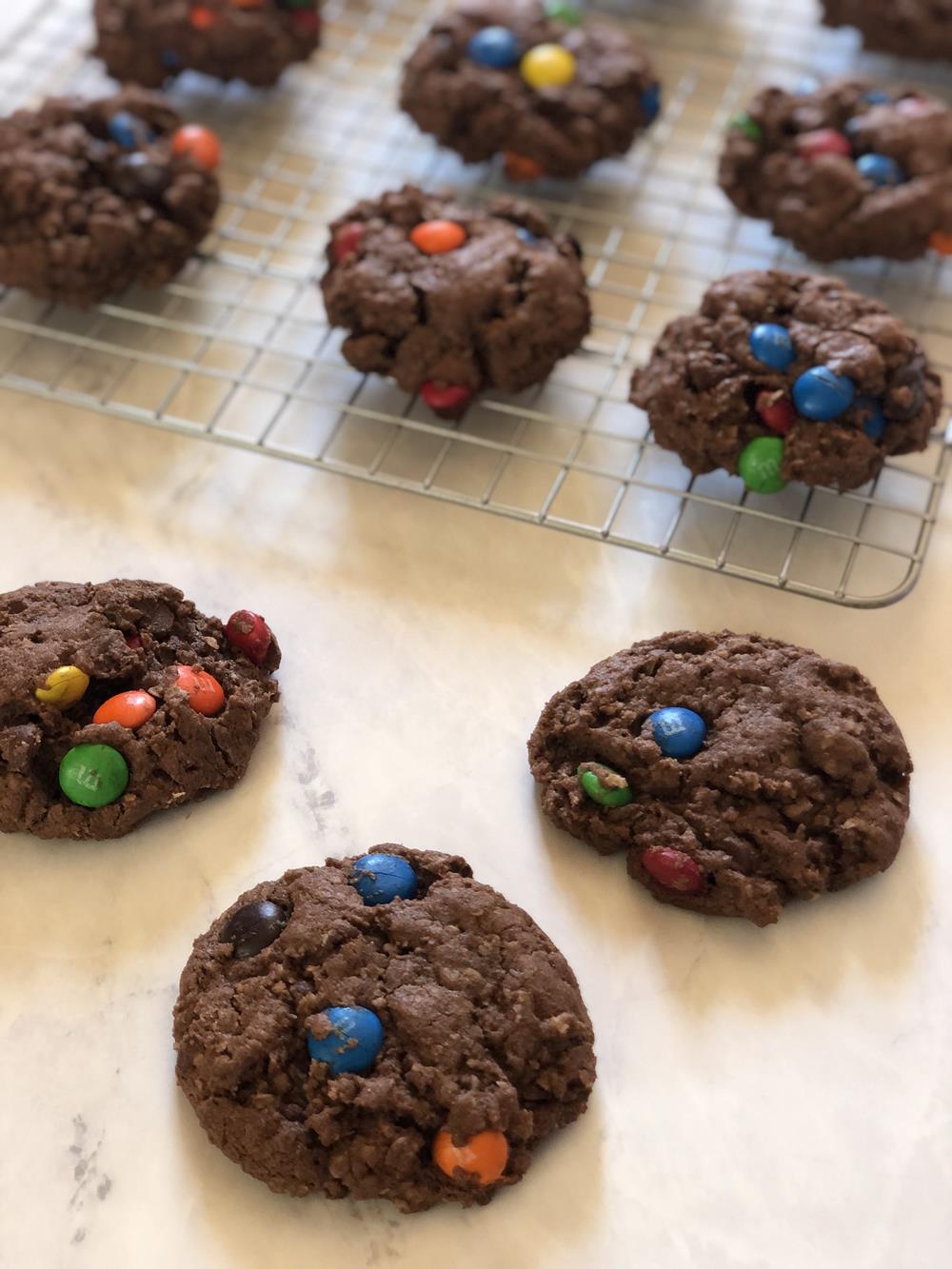 Chocolate Cowboy Cookies on cooling rack on white counter