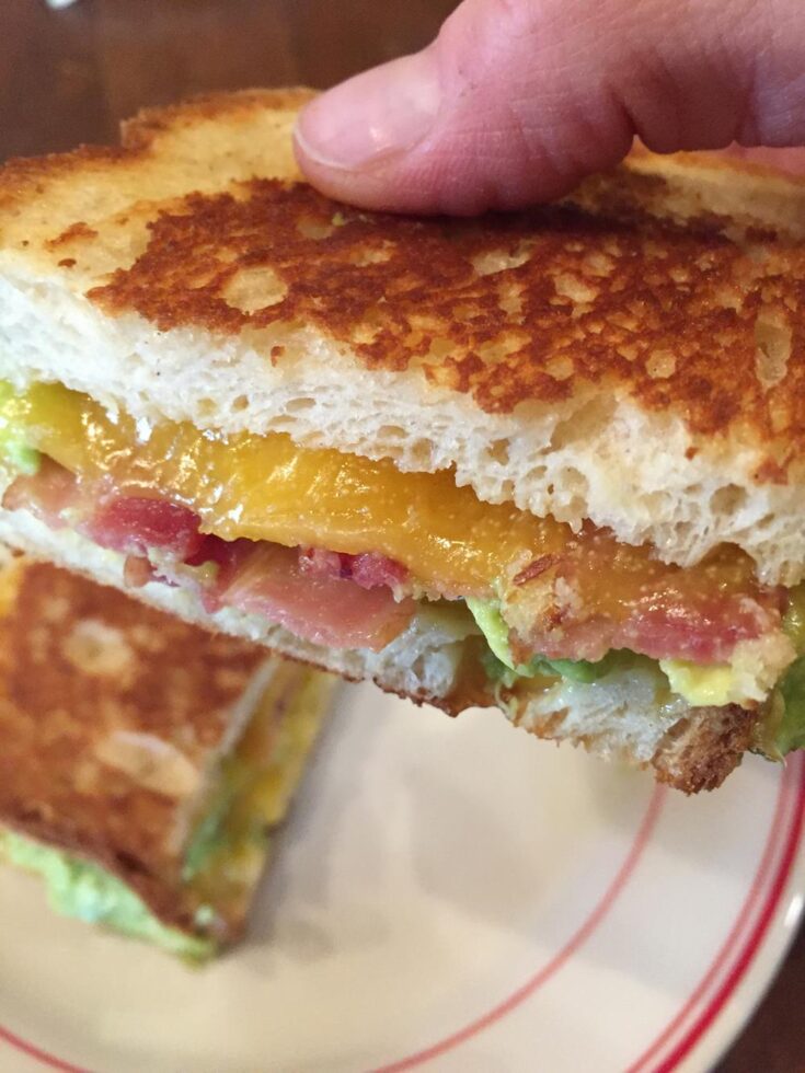 Bacon Avocado Grilled Cheese Sandwich Recipe in hand