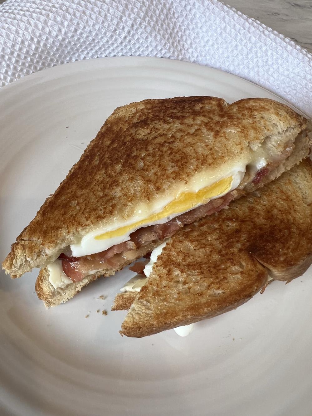 Bacon Egg and Cheese Grilled Cheese Sandwich on white plate