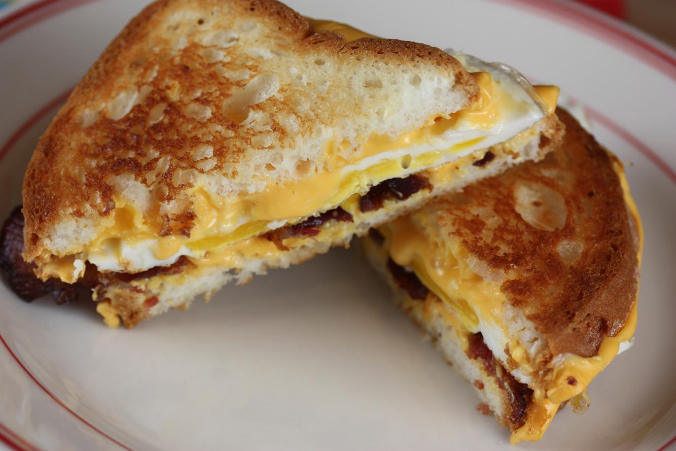 Bacon Egg and cheese grilled cheese sandwich gluten free on white plate