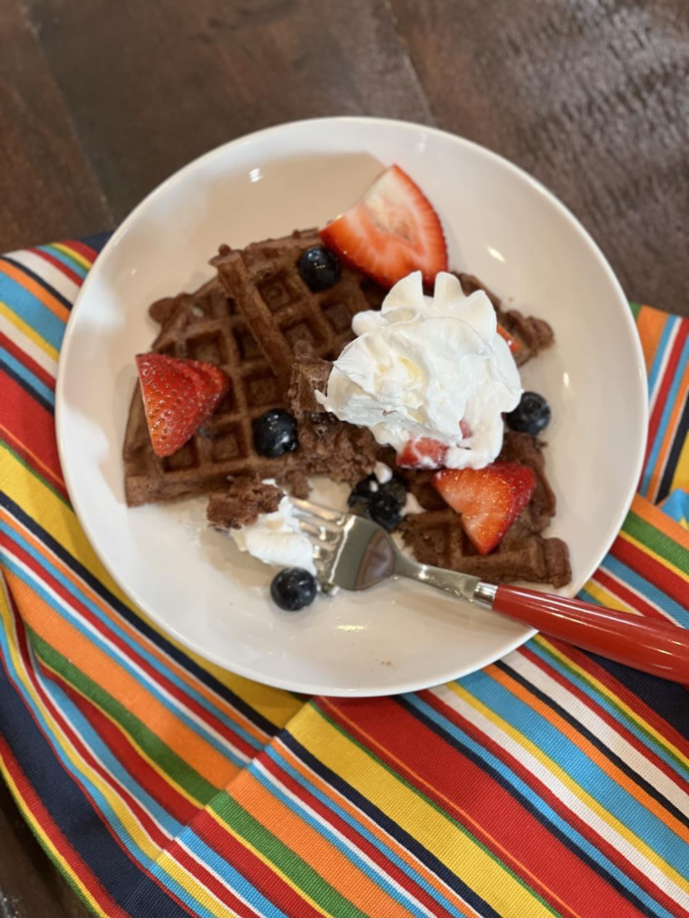 chocolate waffles on white plate with fruit