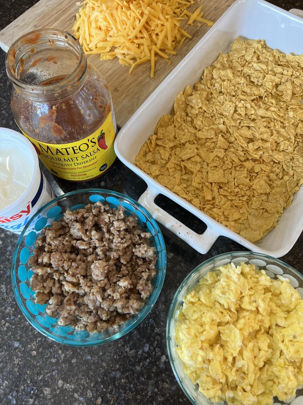 ingredients for Mexican breakfast casserole on dark countertop