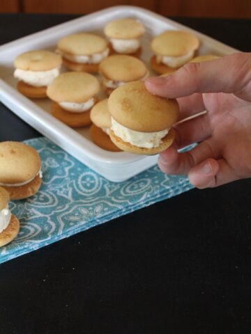 hand holing a vanilla wafer ice cream sandwich