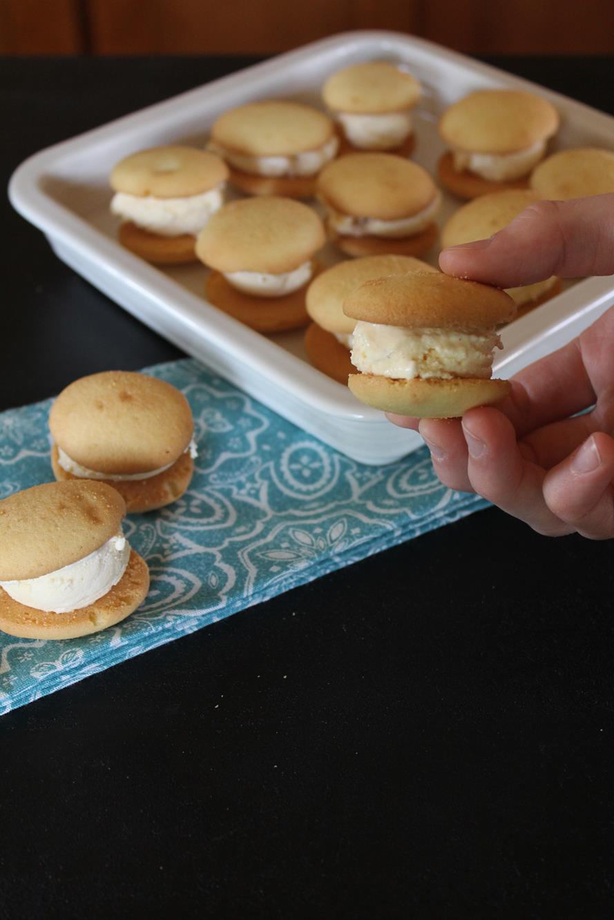 Hand holding vanilla wafer ice cream sandwich