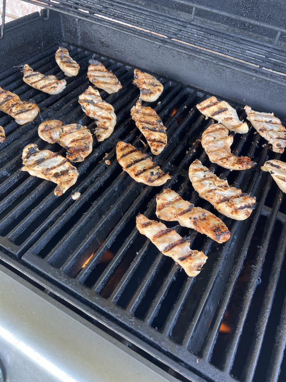 chicken tenders cooking on grill