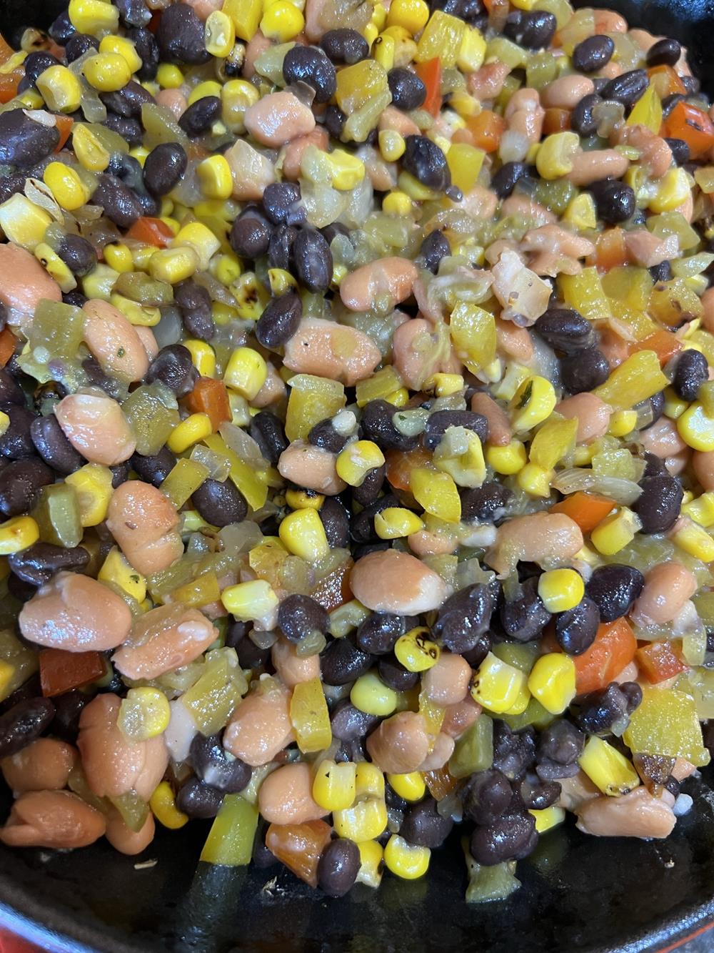 beans, corn, tomatoes and peppers in pan