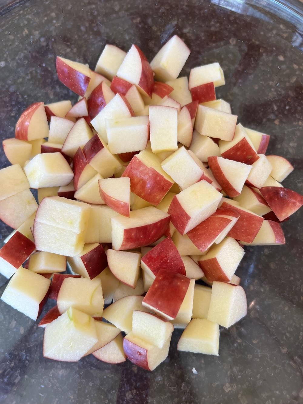 apple cut up in glass bowl