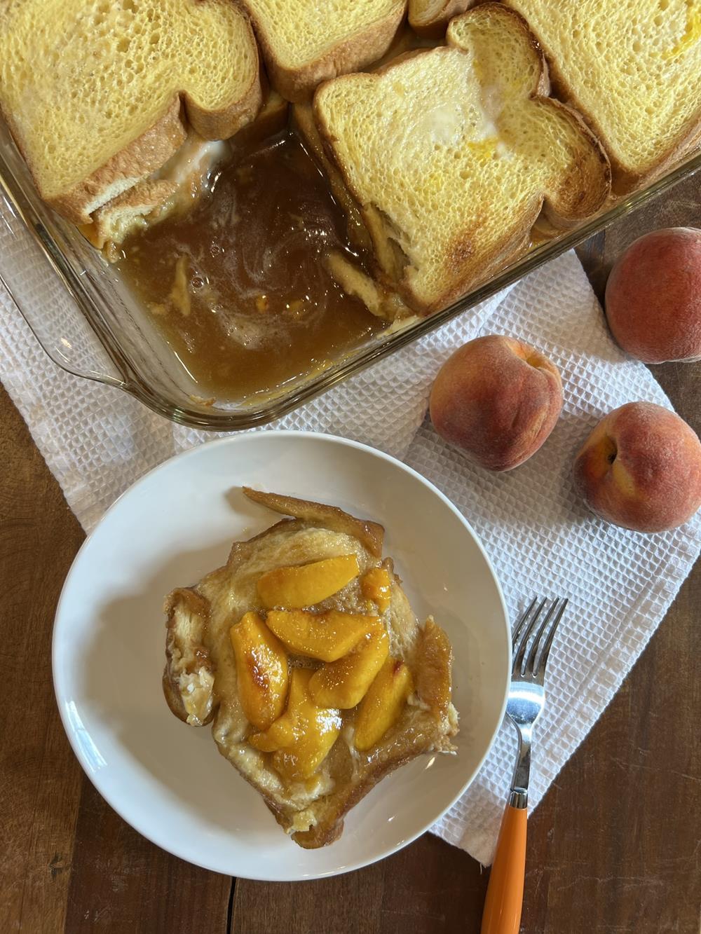 peach french toast in pan and piece on white plate