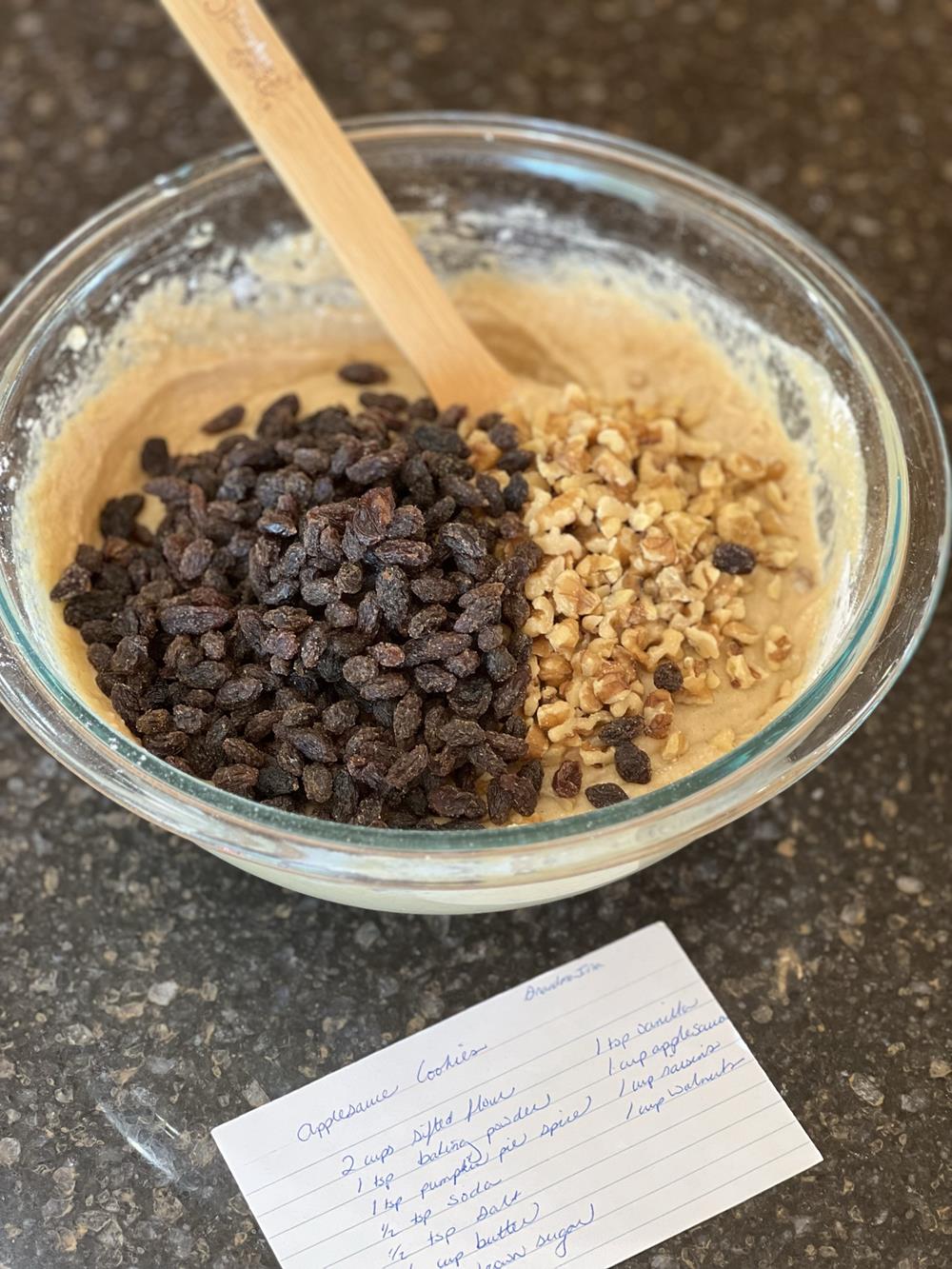 gluten free applesauce cookie batter in glass bowl with wooden spoon