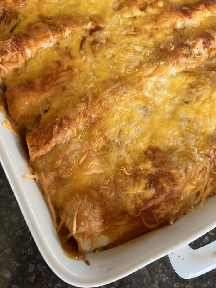 three cheese chicken enchiladas in white pan