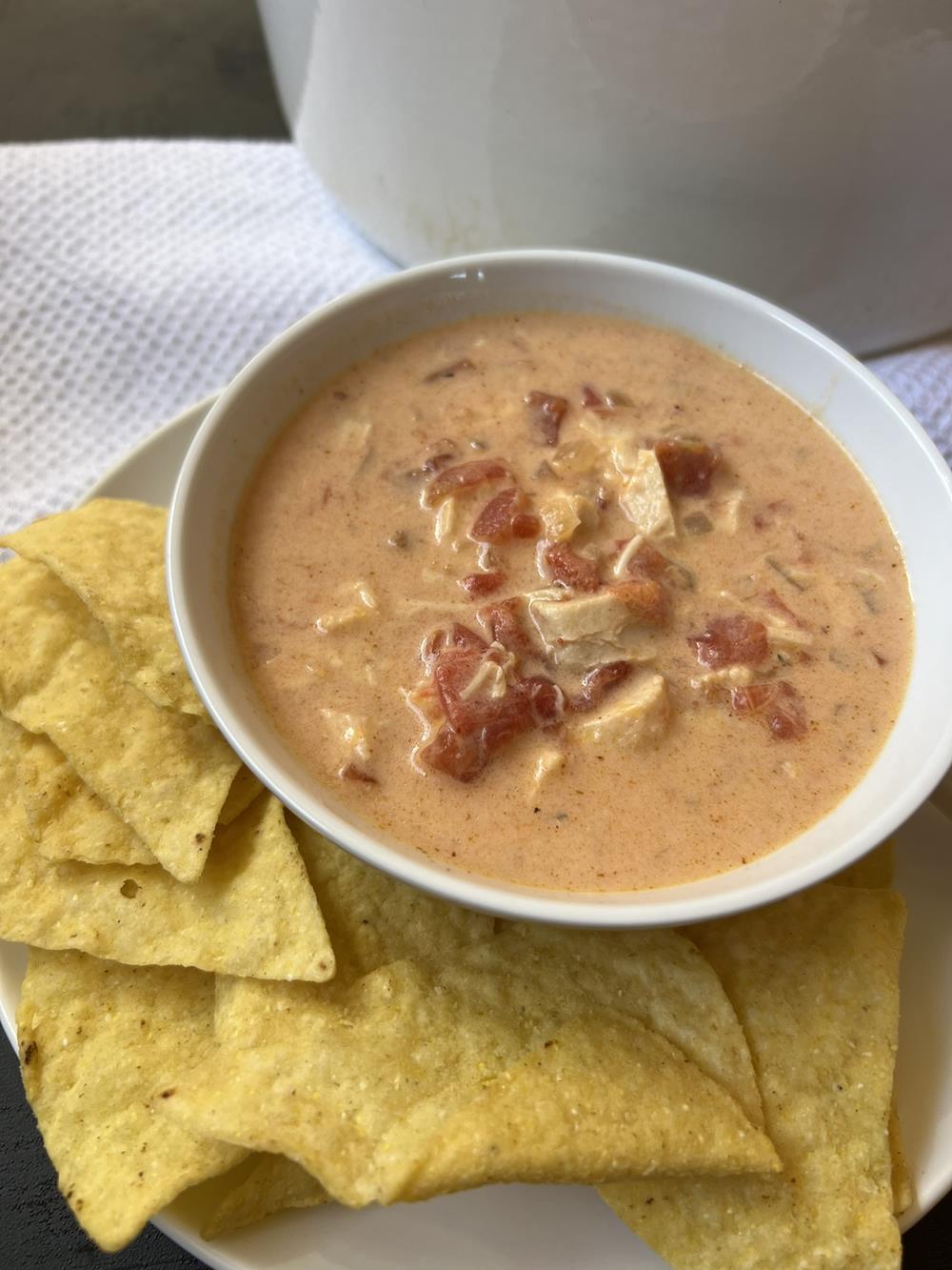 Chicken Queso Soup with chips on white plate