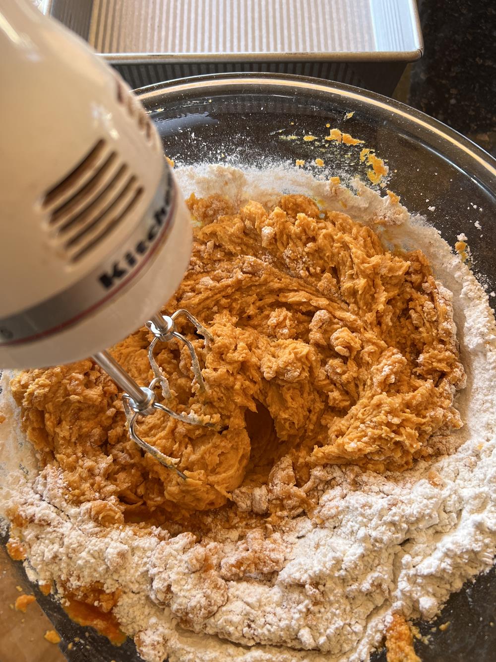 Chocolate Chip Pumpkin Bars Batter in glass bowl with mixer