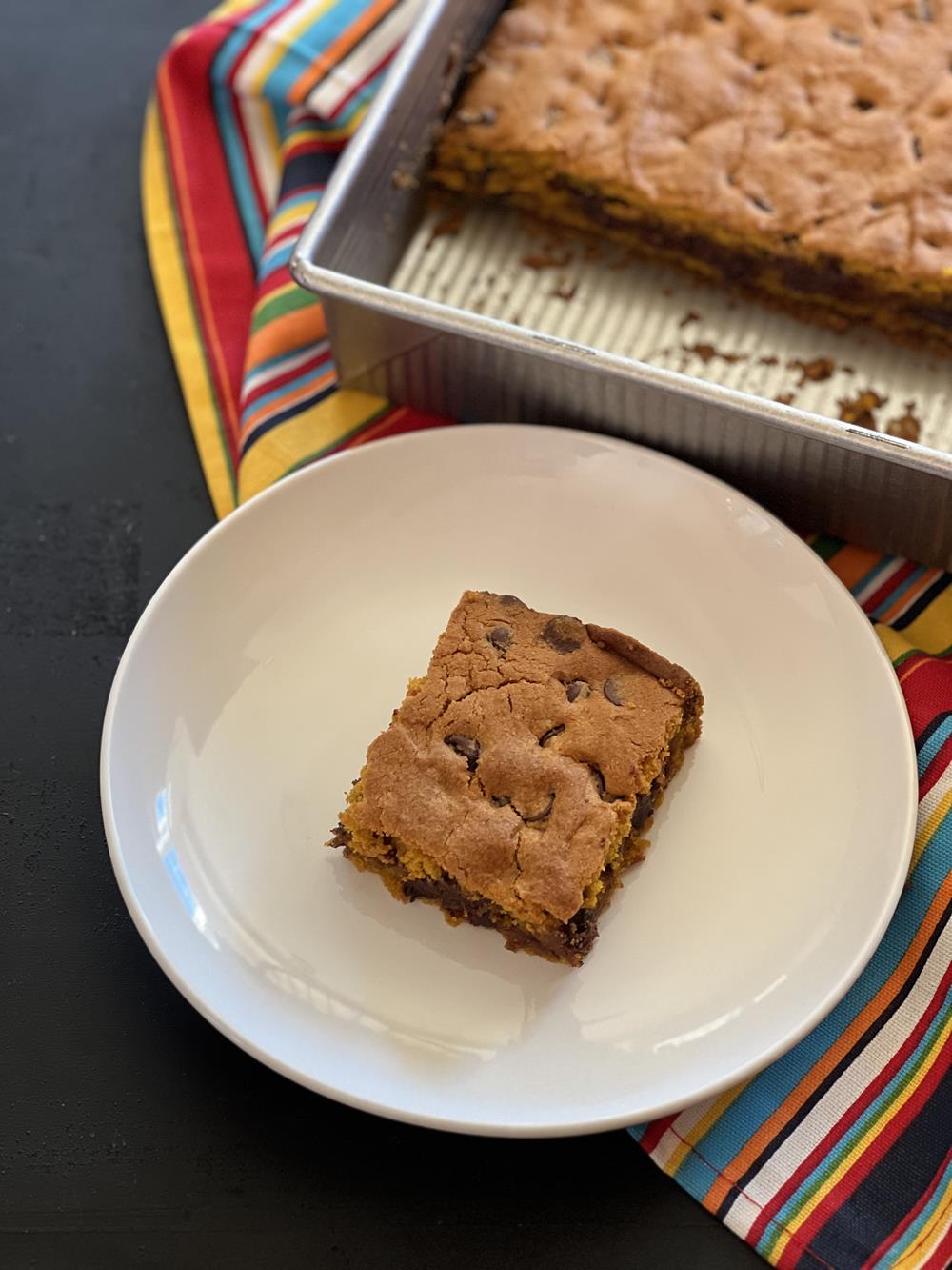 Gluten Free Chocolate Chip Pumpkin Bars on white plate on striped napkin