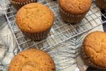 gluten free pumpkin muffins on cooling rack with napkin in background