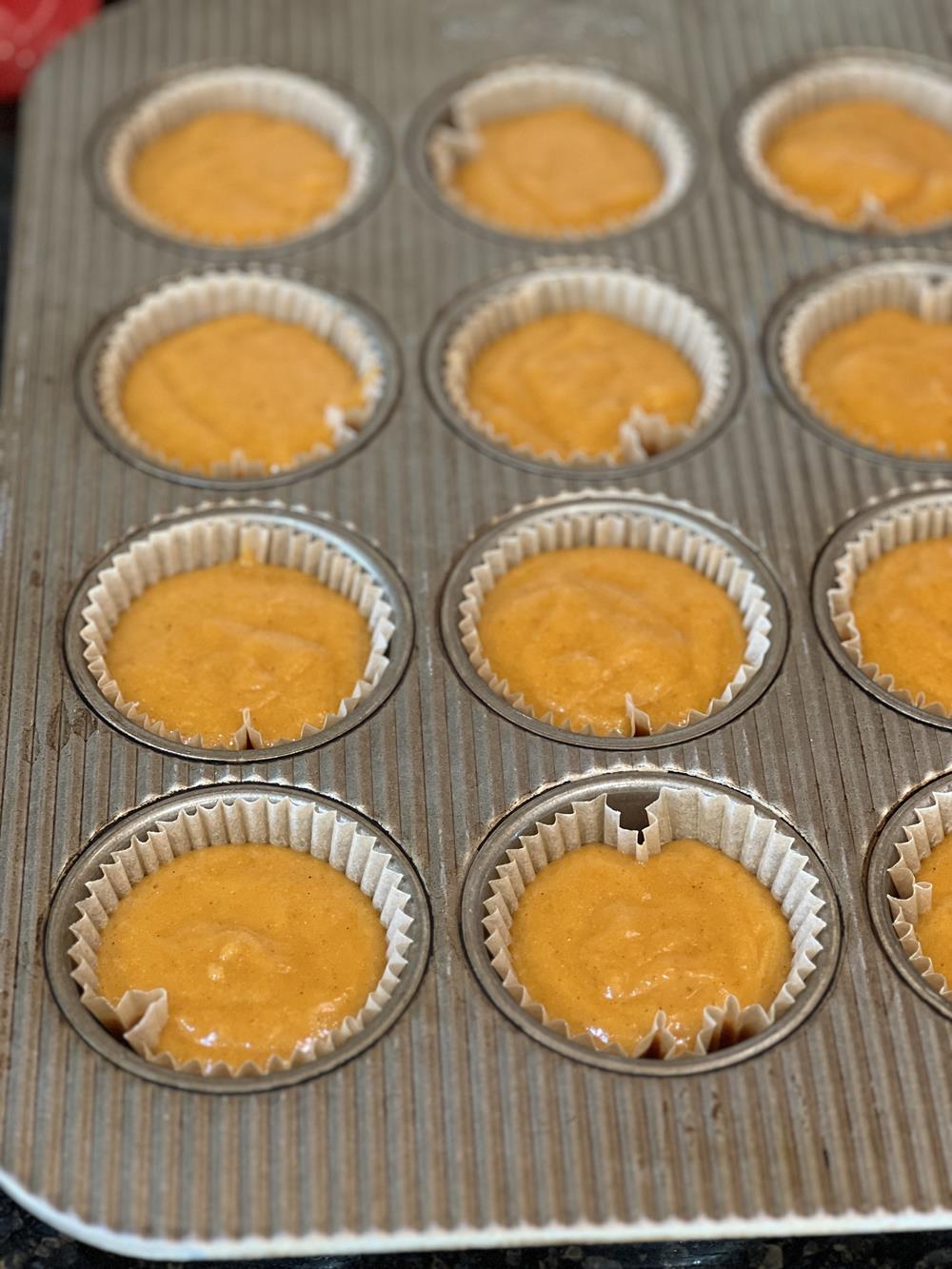 pumpkin muffin batter in muffin pan