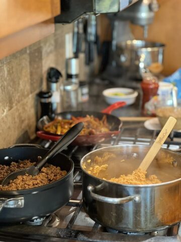 rice, ground meat, onions and pepper on stove