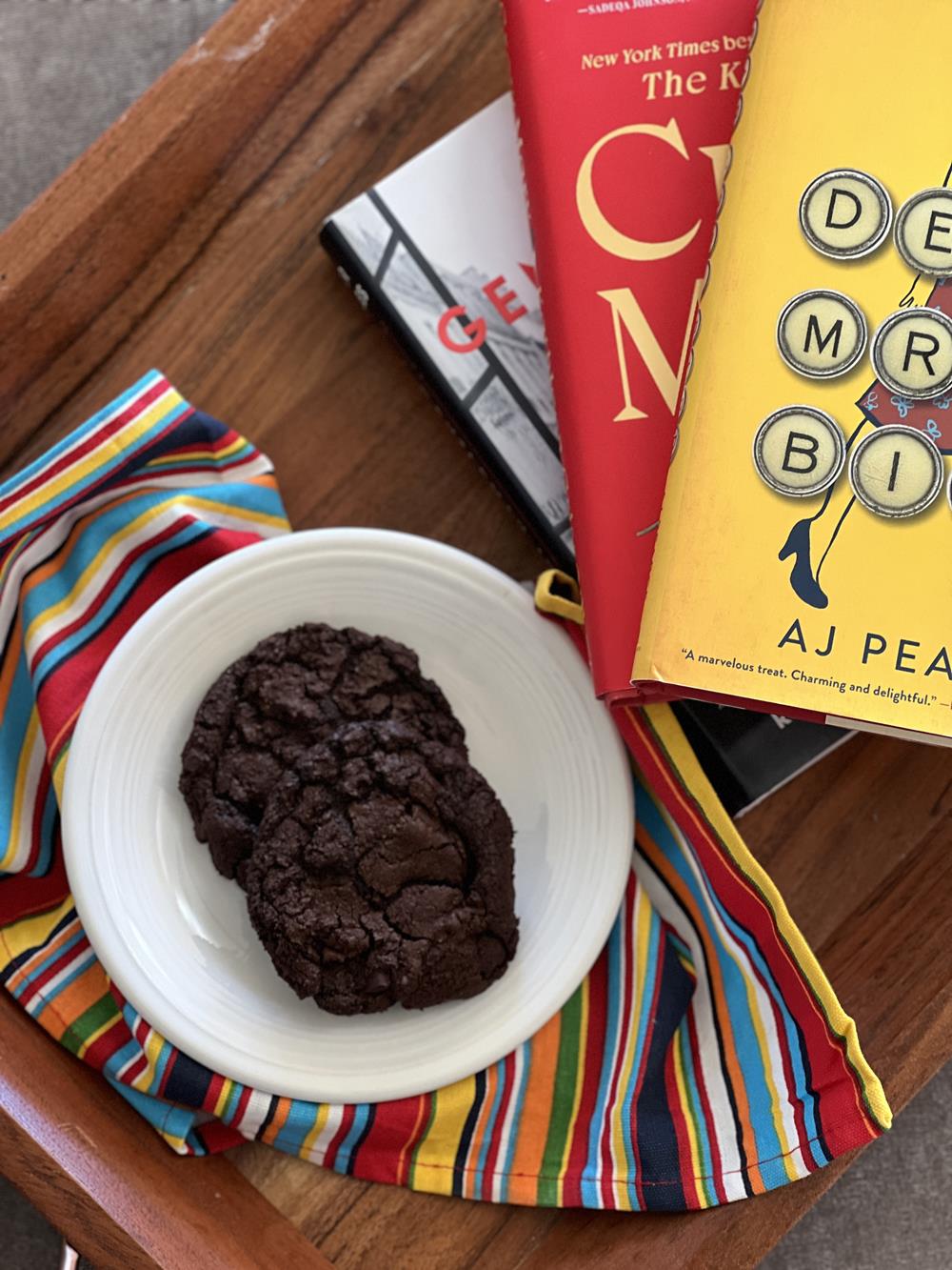three books and a cookies on a white plate
