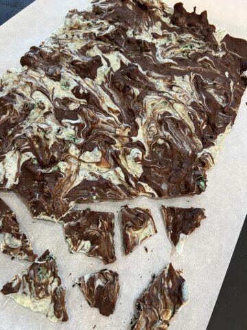 Mint Chocolate Cookie Bark with Oreos on parchment paper