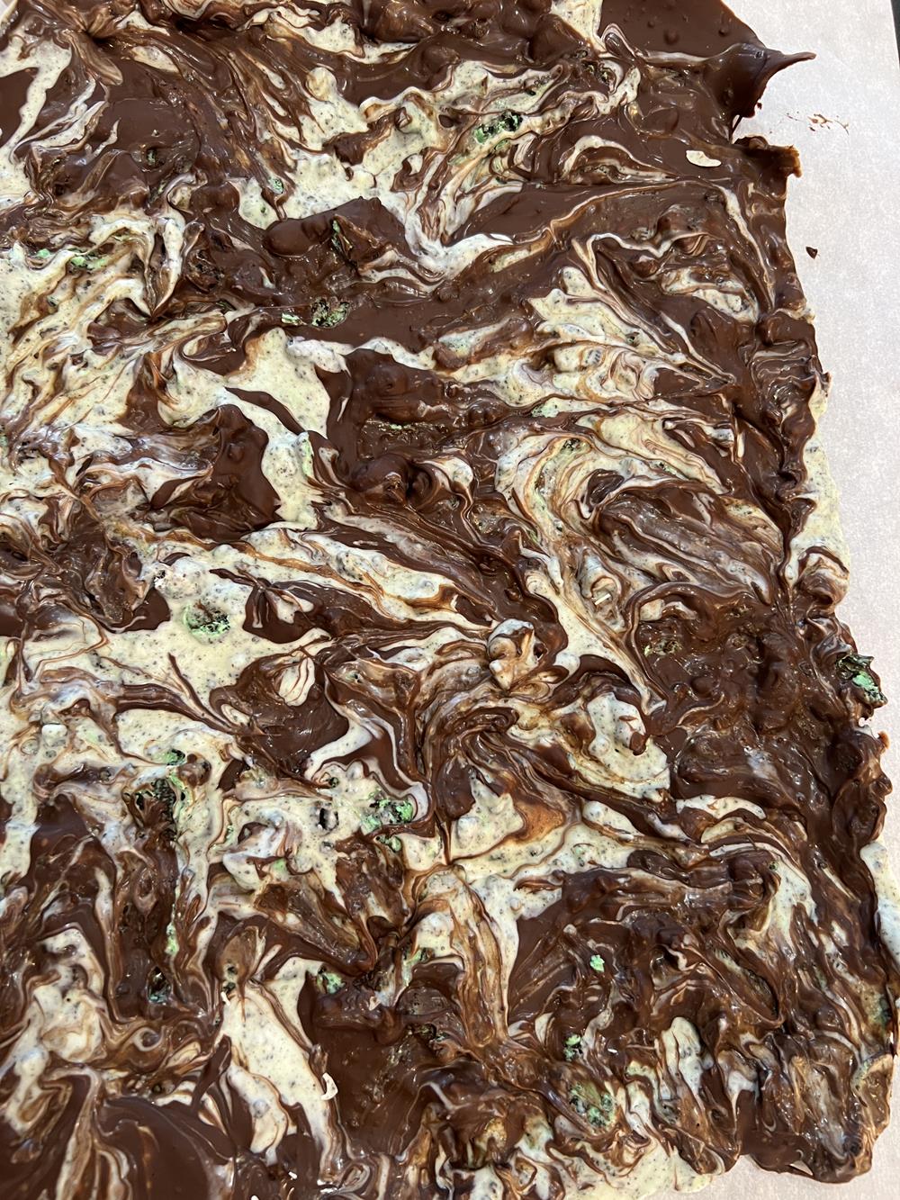 Mint Chocolate Oreo Cookie Bark on parchment paper