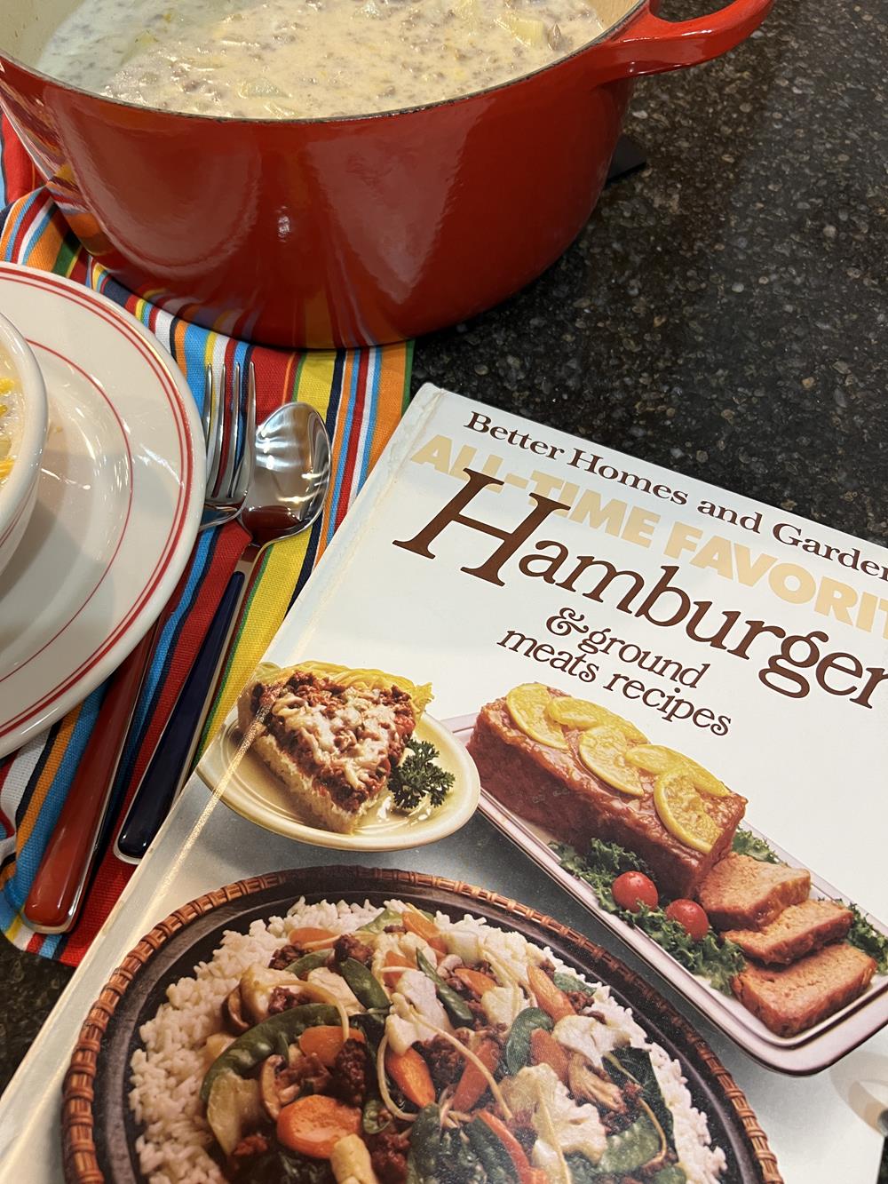 vintage hamburger cookbook next to a pot of soup