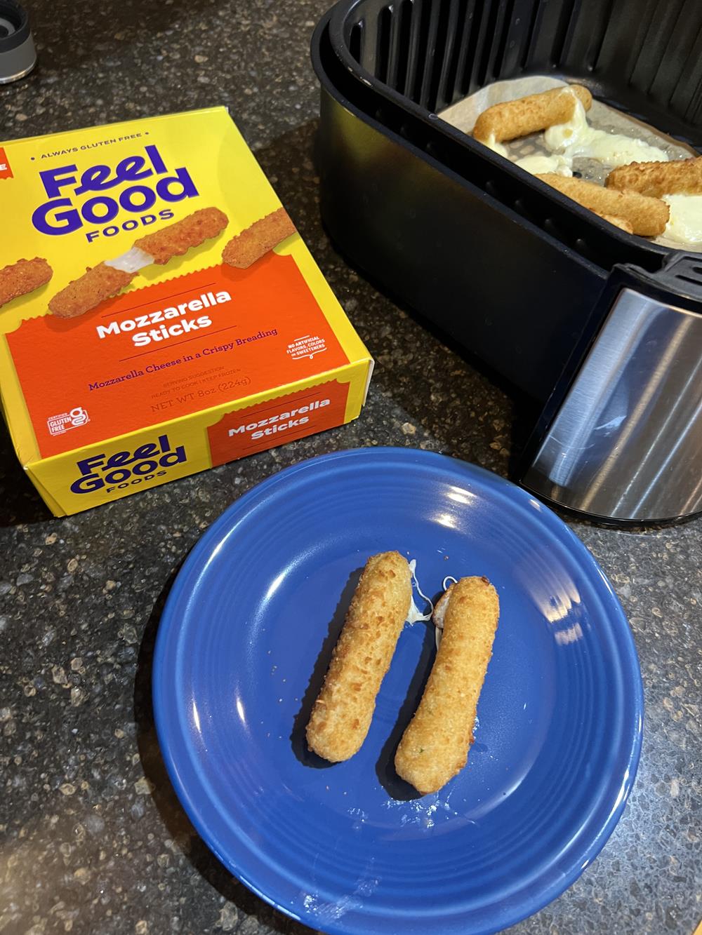 Feel Good Gluten Free Mozzarella Sticks on plate with box in the background