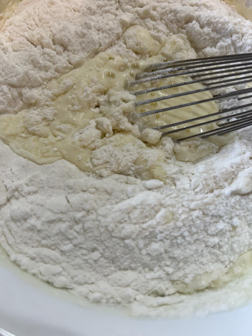 pancake batter in white bowl with whisk