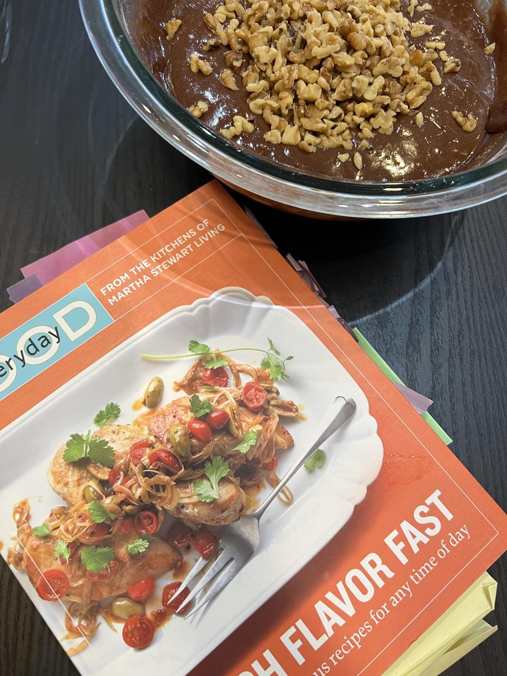 brownie batter in glass bowl with everyday food cookbook