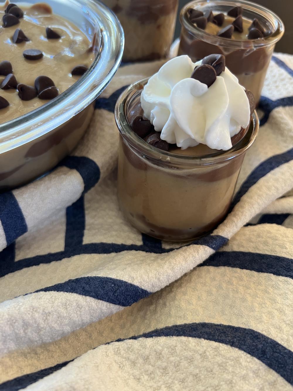 homemade pudding in glass bowl with whipped cream