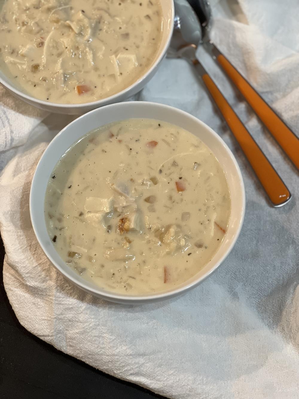 chicken soup in white bowls on white background