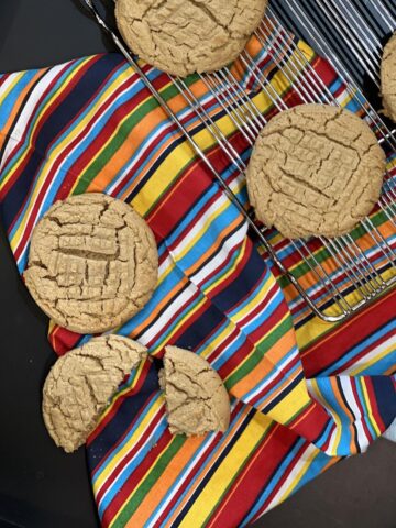 Martha Stewart Peanut Butter Cookies on striped napkin with cooling rack in background