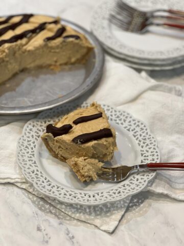 piece of Peanut Butter Chocolate Mud Pie on white plate with fork