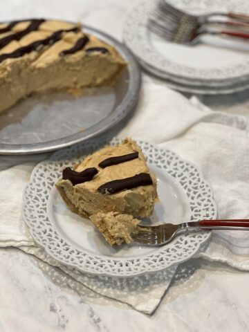 piece of Peanut Butter Chocolate Mud Pie on white plate with fork