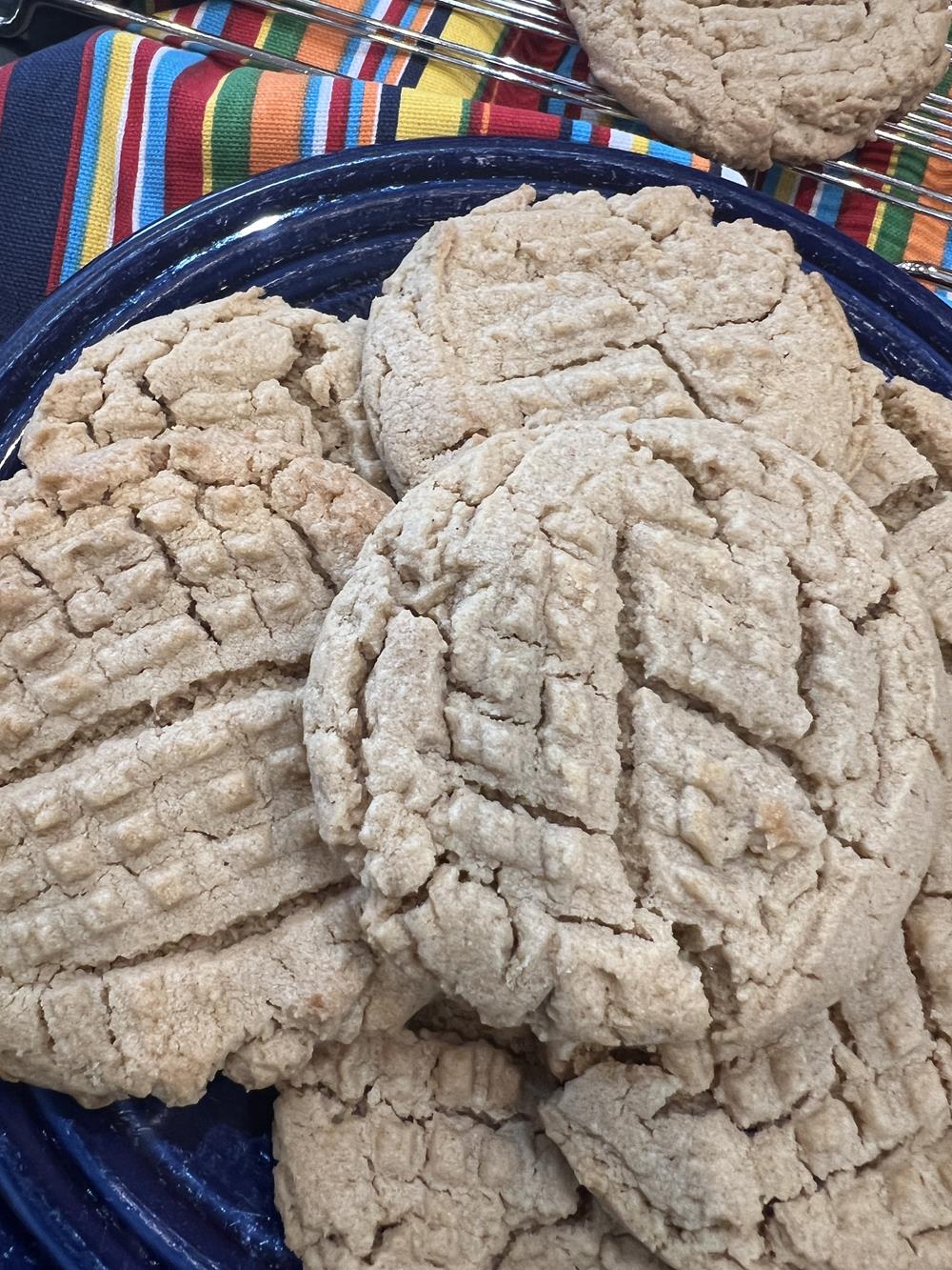 peanut butter cookies on blue plate with striped napkin in background