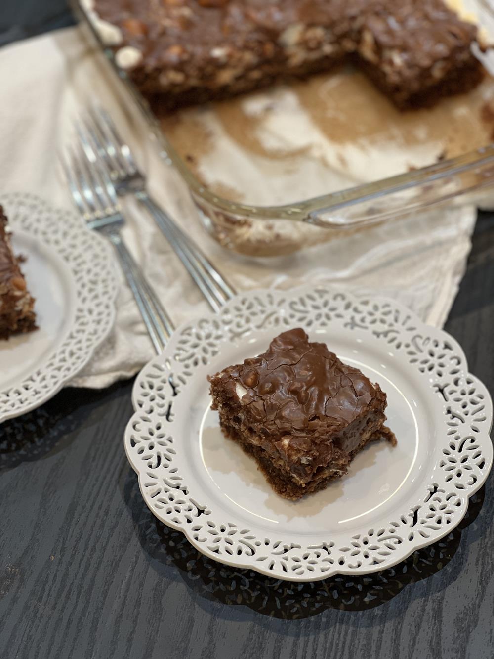 Mississippi mud cake on white plate with cake in background