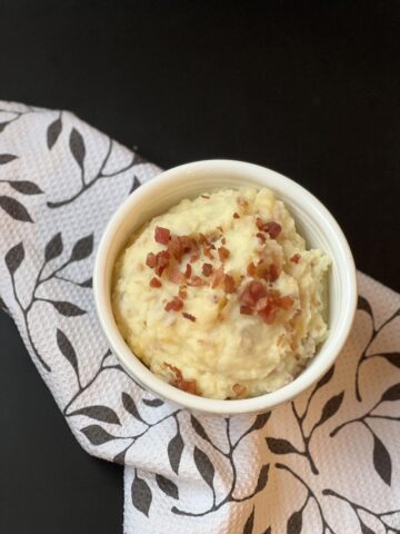 white bowl of loaded mashed potatoes