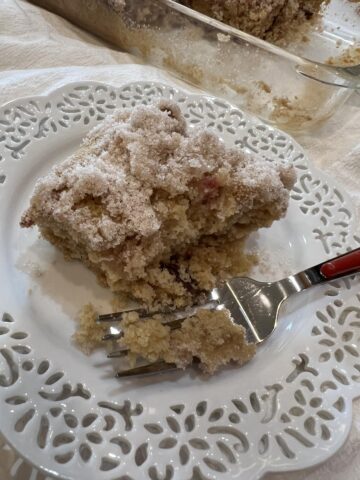 gluten free rhubarb cake on white plate with red fork