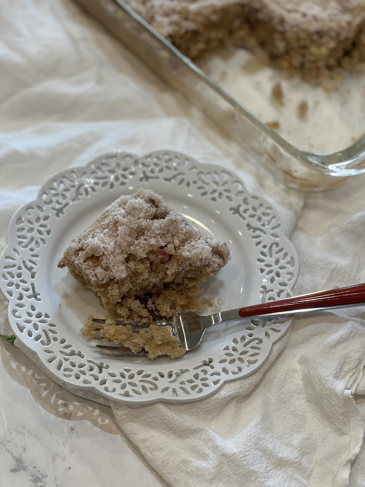 gluten free rhubarb cake on white plate on white napkin