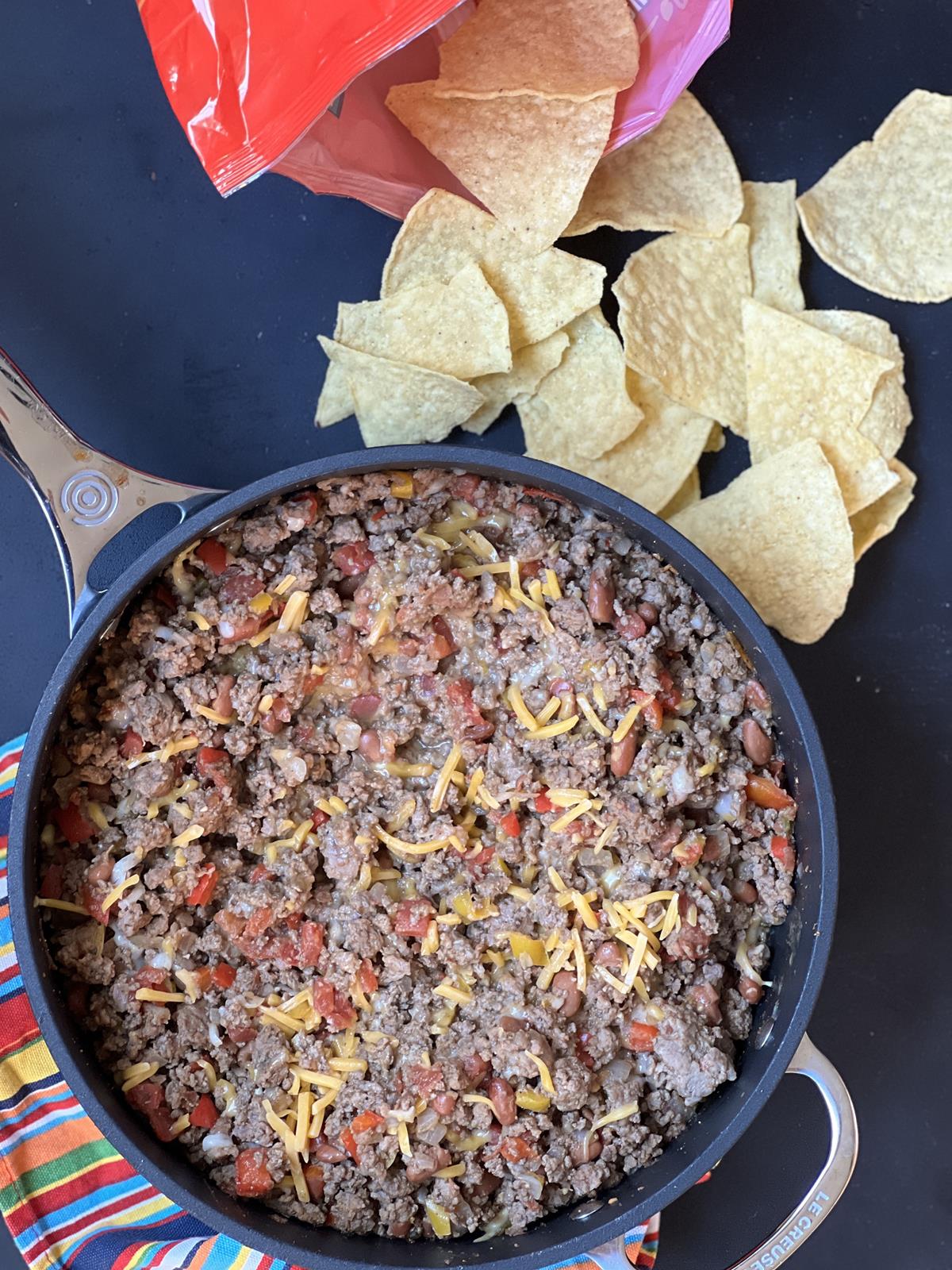 skillet tacos with bag of chips on black background