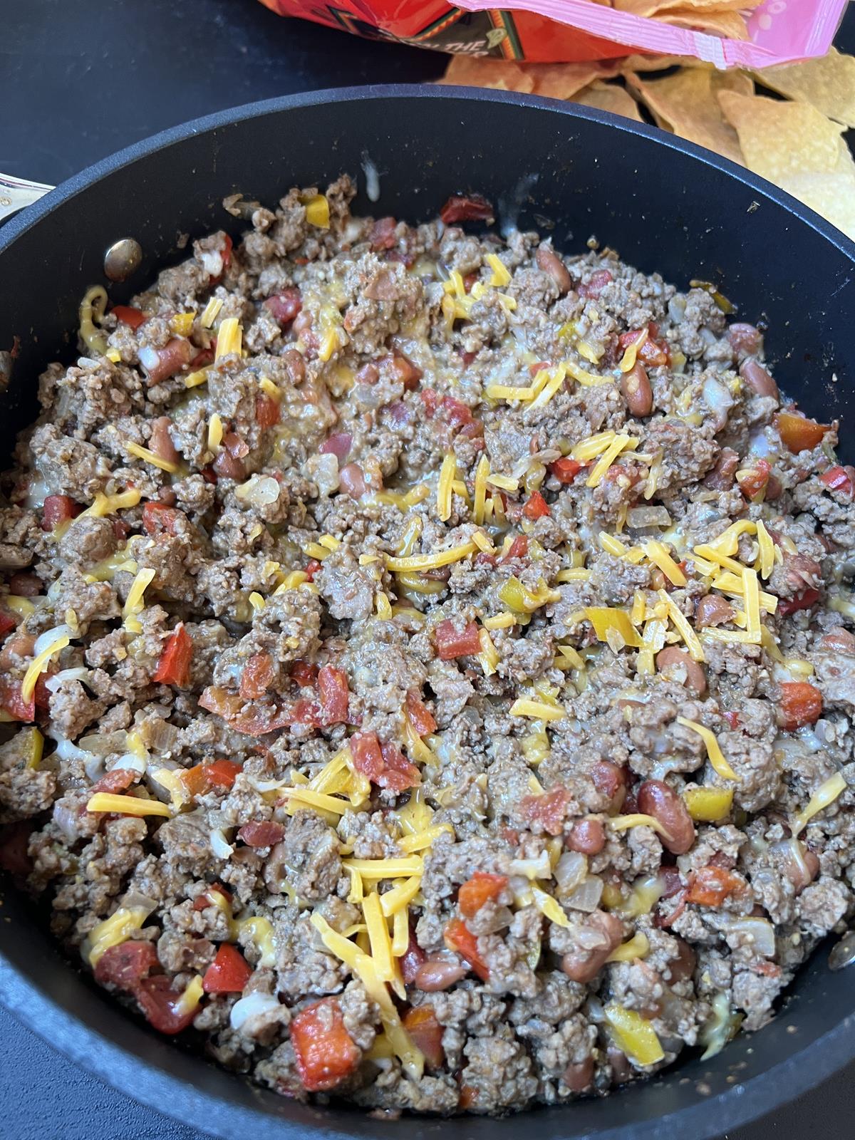 skillet tacos with cheese in pan with chips in background