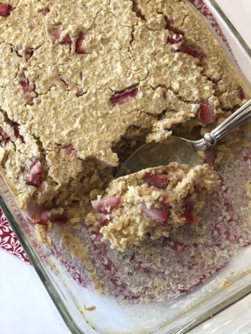 strawberry baked oatmeal in glass baking dish with spoon