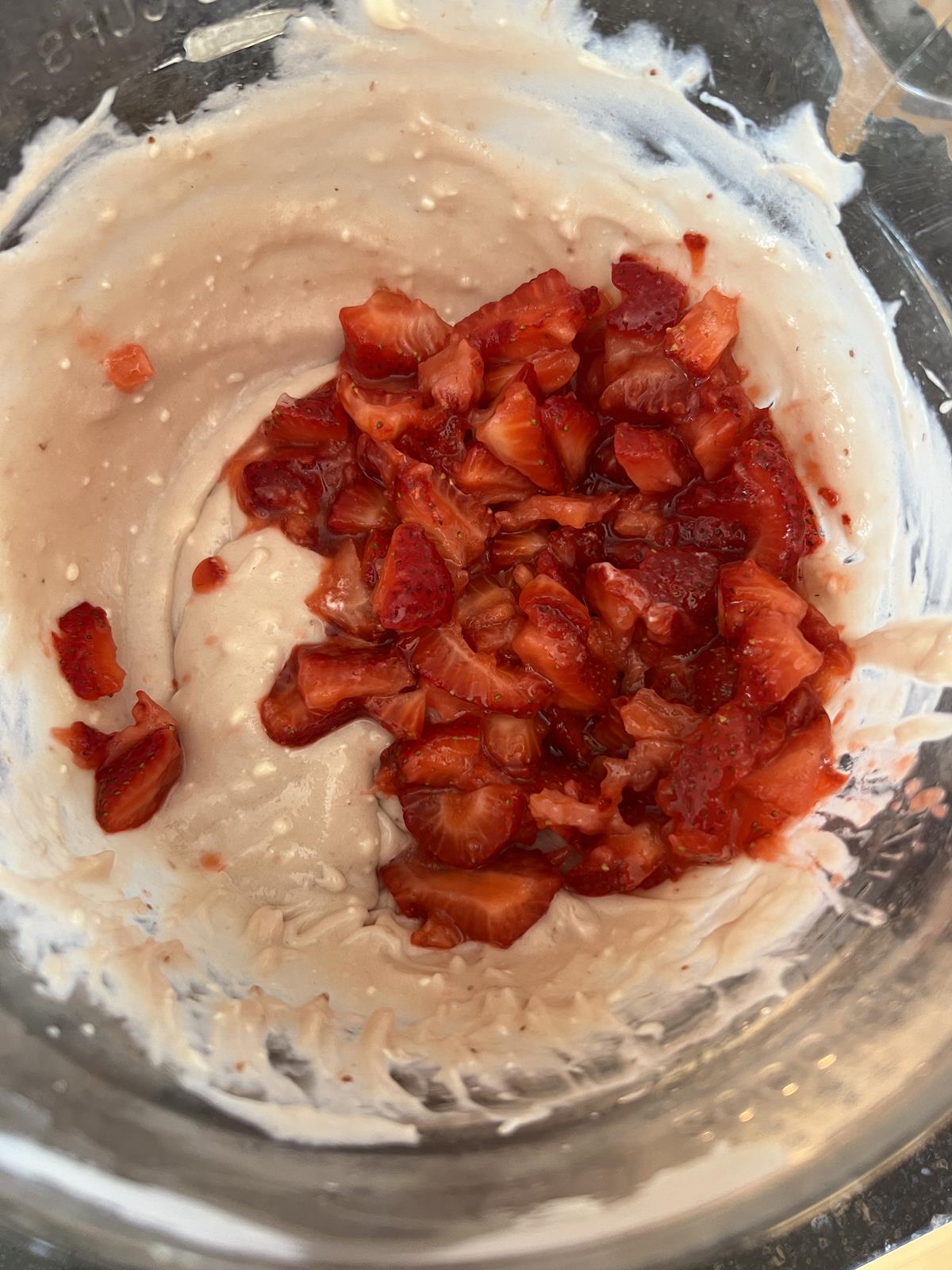 no bake berry pie batter with strawberries in glass bowl