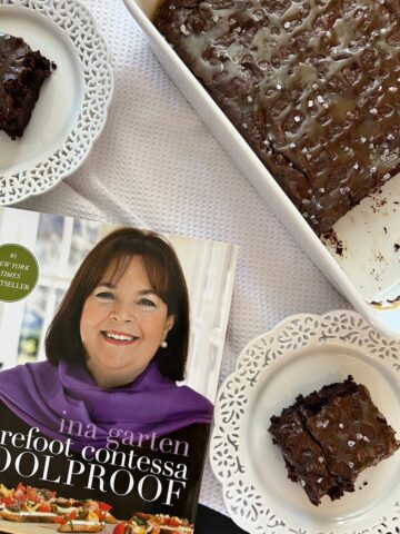brownies on two white plates and in white pan with cookbook in front