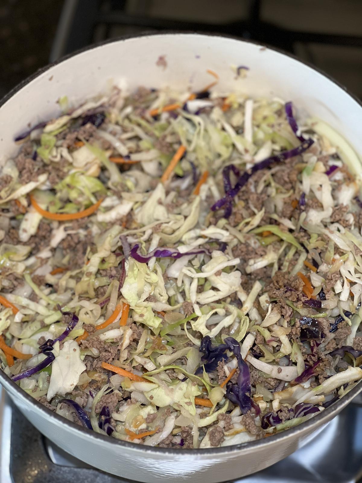 egg roll in a bowl in white cast iron pan