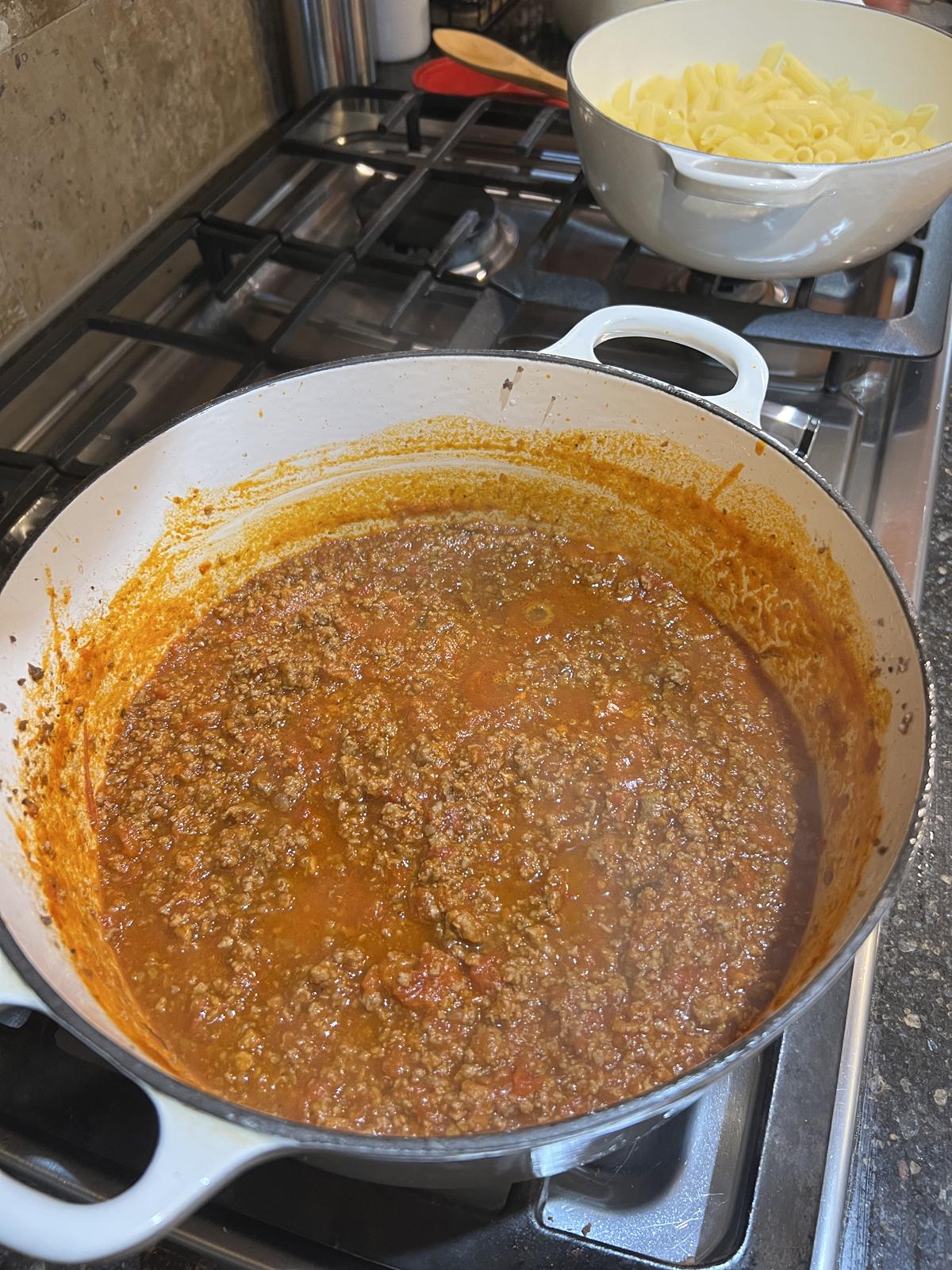 pasta and pasta sauce in two white pans