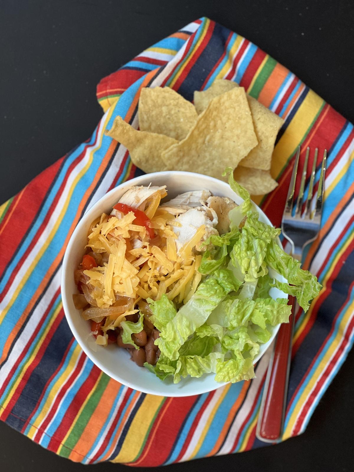 Chicken Fajita Bowl and chips on striped napkin