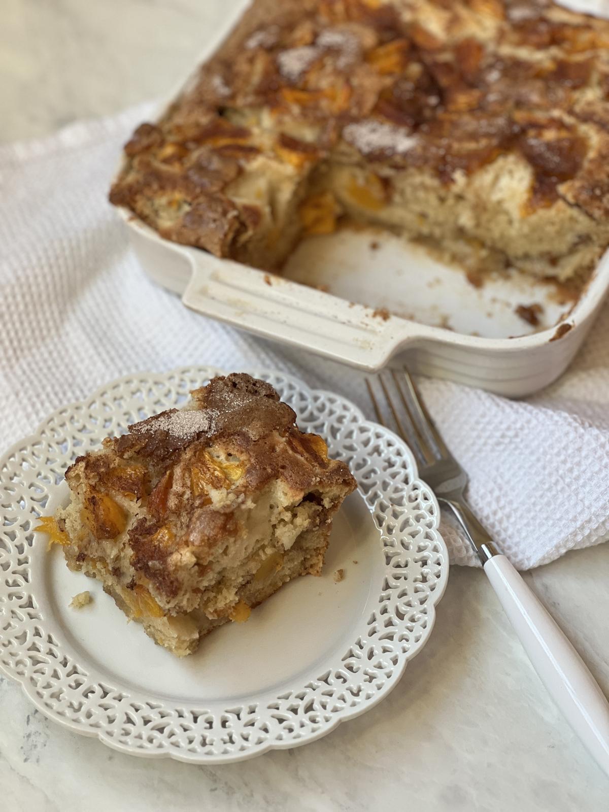 peach cake on white plate and in white cake pan